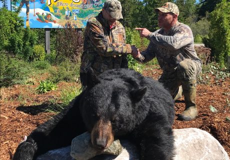 Happy Hunters With Black Bear