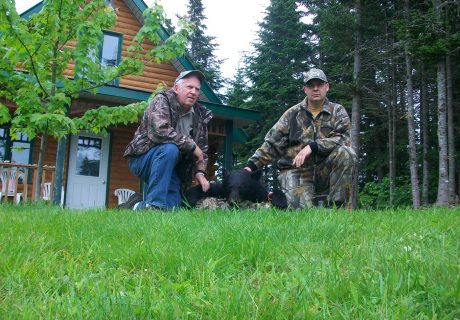 Two Men With Black Bear